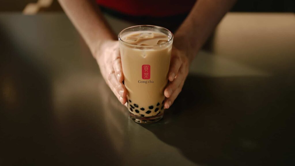 Bubble tea drink with hands covering the sides